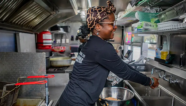 Owner of a food truck company washing her hands.
