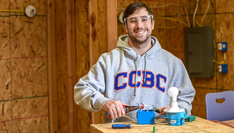 Student working on electrical outlet