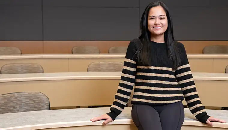 Student posing for a photo outside on campus