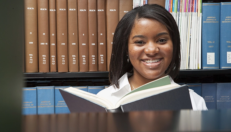 Female student in library with books