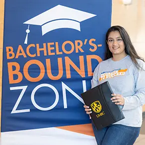 Archana Thakkar standing next to a banner that reads "Bachelor's-bound?"