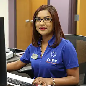 CCBC admission counselor seated at her desk smiling