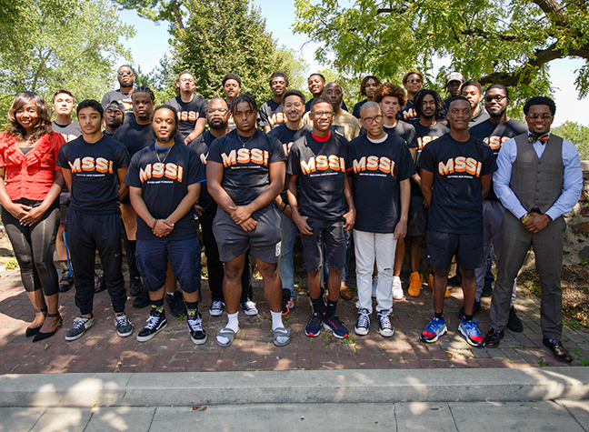 Group of young men on first day of MSSI orientation smiling at camera