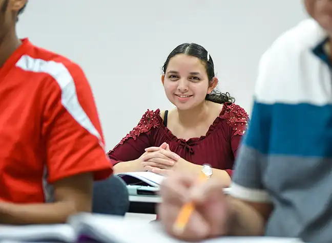 Female student smiling for photo in ESOL class