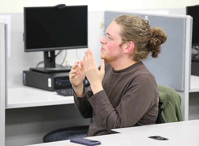 male student using ASL in class