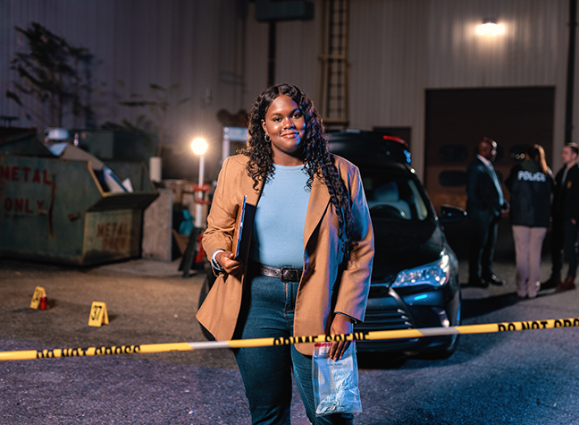 Female student at a crime scene with caution tape