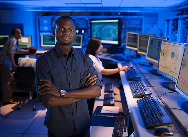 IT student posing in computer lab