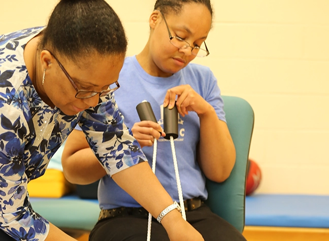 Occupational therapy assistant helping a patient