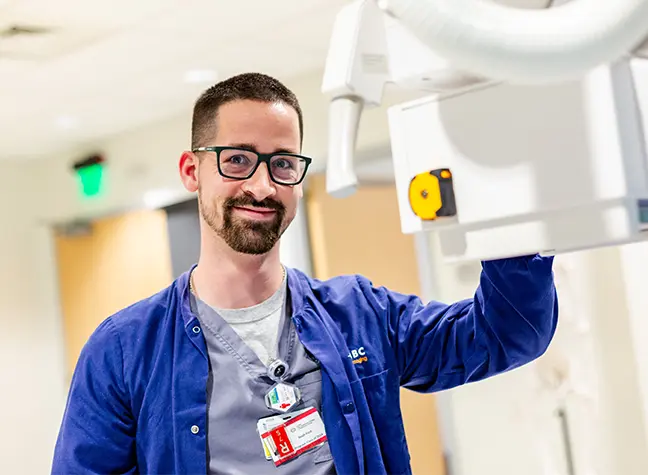 Radiology student using machine in lab viewing image