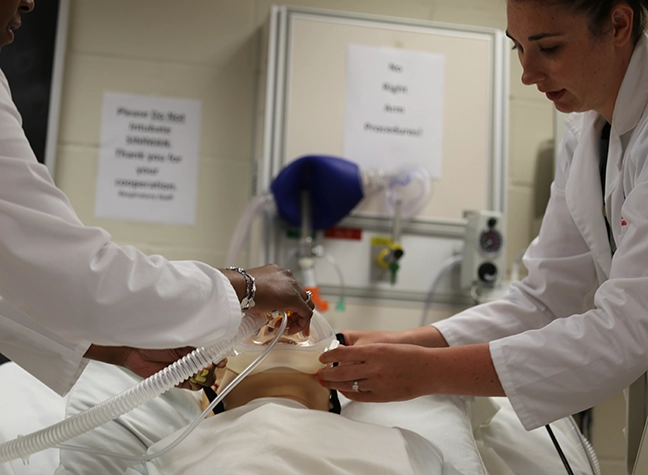 Man holding equipment in respiratory lab