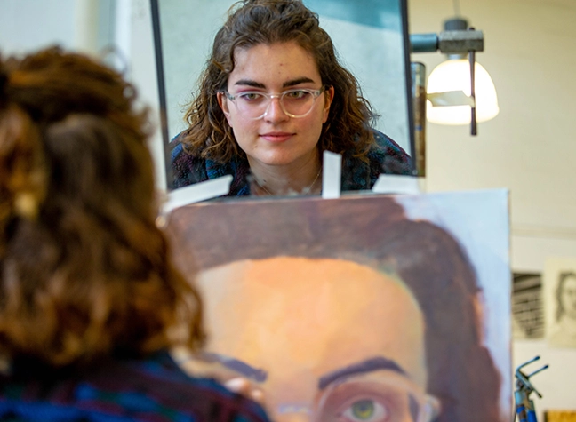 Woman painting her self portrait