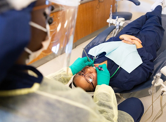 Dental hygiene student in his scrubs.