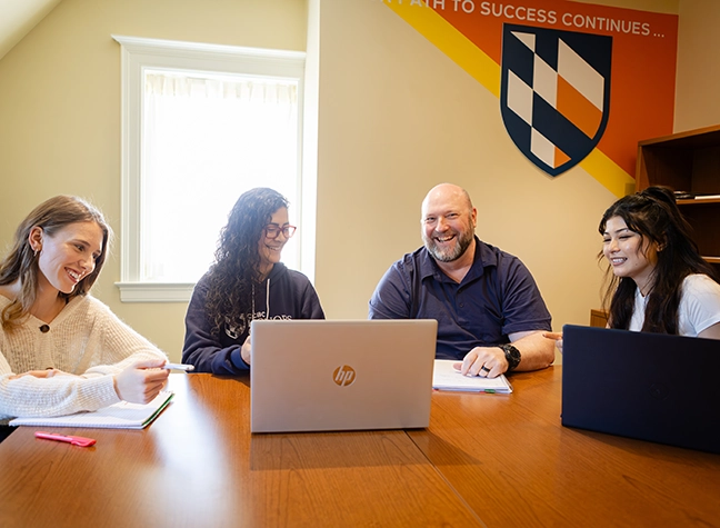 Group of honors students posing for a photo next to large CCBC letters