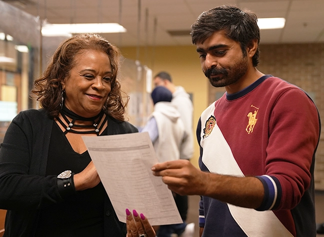 Staff member assisting a student