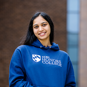 Headshot of Chitpreet in blue honors college sweatshirt