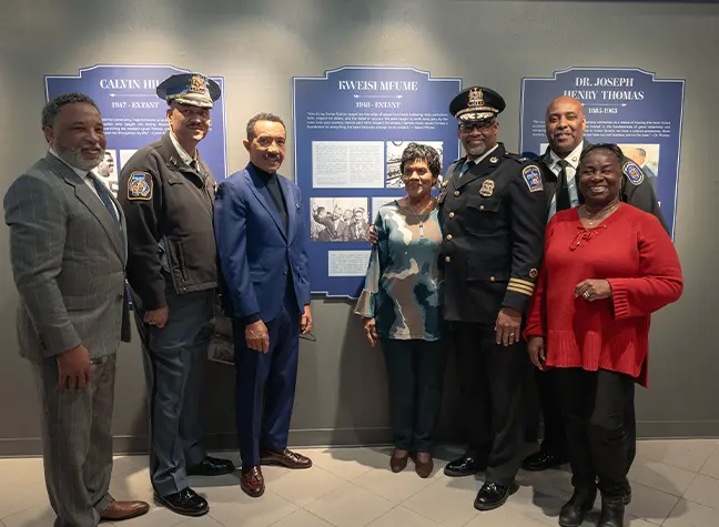 Seven people pose as picture is being taken at Turner Station